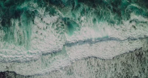 Top Down View of Waves Rolling Across Tropical Shoreline Video stock 330590203