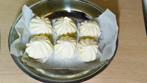 Top-down view of white Chinese steamed pork dim sum bao dumpling served on .. Stock Footage 318246350