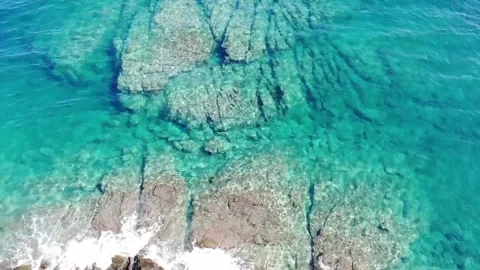 Top down view of white cliffs with crystal clear water in Kavala, Greece Stock Footage 143965736