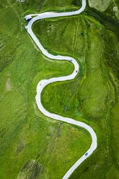 Top down view of white serpentine on green hills, Dolomites Stock Photos
