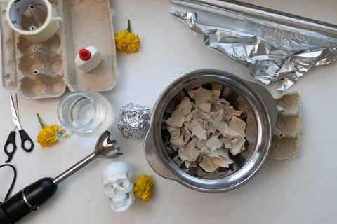 Top-down view of a white skull prop being decorated for Dia de los Muertos, w Stock Photos