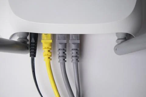 Top-down view of a white wireless router back panel with one black power ca.. Stock Photos