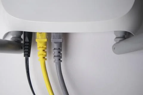 Top-down view of a white wireless router back panel with one black power ca.. Stock Photos