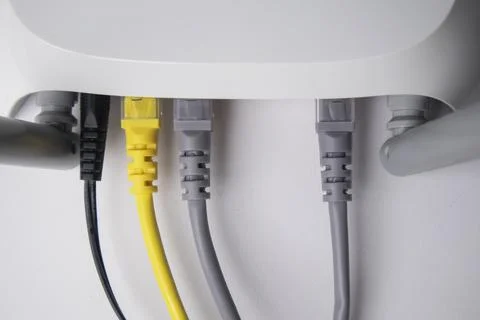 Top-down view of a white wireless router back panel with one black power ca.. Stock Photos