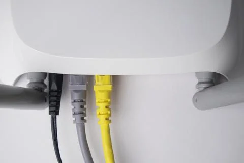 Top-down view of a white wireless router back panel with one black power ca.. Stock Photos