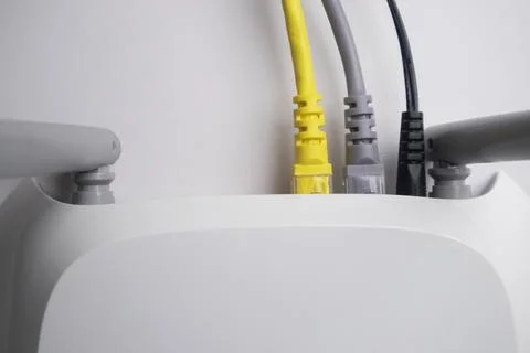 Top-down view of a white wireless router back panel with one yellow Etherne.. Stock Photos