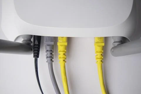 Top-down view of a white wireless router back panel with one black power ca.. Stock Photos