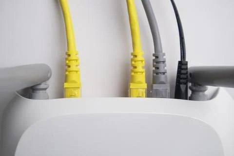 Top-down view of a white wireless router back panel with two yellow Etherne.. Stock Photos