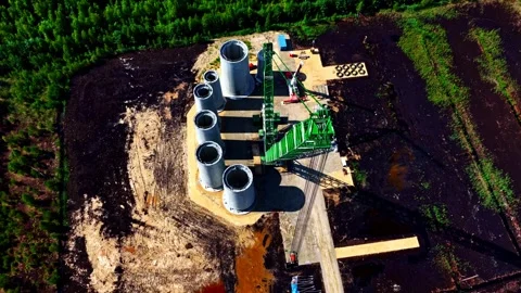 Top-down view of a wind turbine foundation site with large concrete tower Stock Footage 325765320
