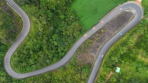 Top-down view of winding mountain pass with hairpin turns, Ta Dung Stock Photos
