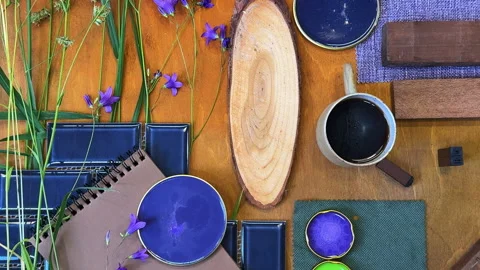 Top-down view of a woman creating a mood board in blue and green tones with fore Stock Footage 311846043