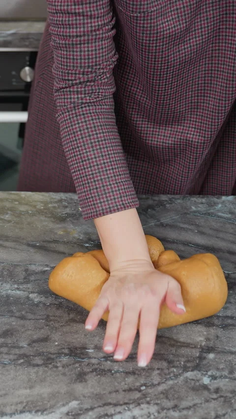 Top down view of woman kneading fresh dough with right hand on kitchen counter Stock Footage 320364890