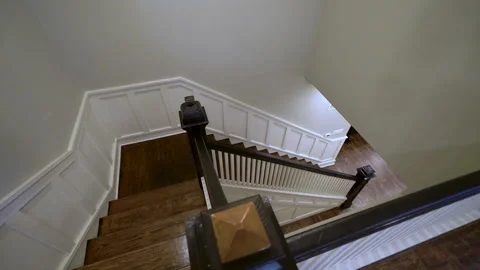 Top down view of wooden staircase with dark railing Stock Footage 345692438