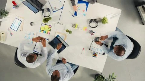 Top down view of work team engaged in negotiation consulting Stock Photos