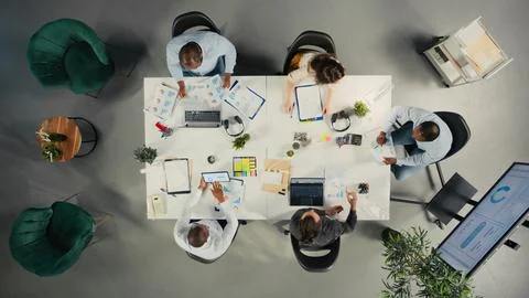 Top down view of work team in multinational company analyzing metrics Stock Photos