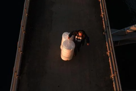 Top Down View of Worker Carrying Bubble Wrap on Halic Bridge Stock Photos