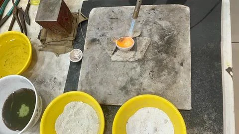 Top down view of workspace with bowls, torches and crucible Stock Photos