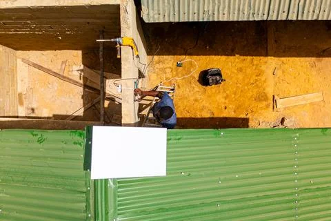 Top down view of young african man installing a Starlink satellite internet 库存照片
