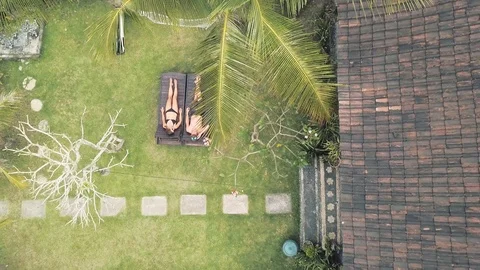 Top-down view of young caucasian surf couple in swimsuits in resort Stock Footage 119702085