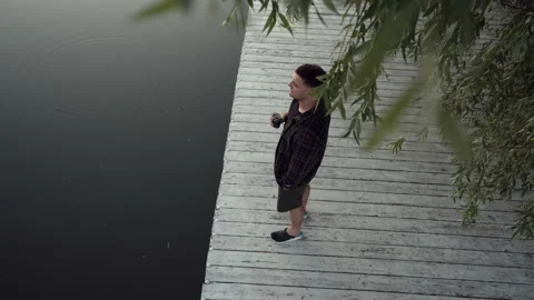 Top down view of a young man standing on a wooden deck Stock-Footage 203793726