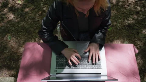Top-Down View of Young Woman Typing on Laptop Outdoors Stock Footage 339031350