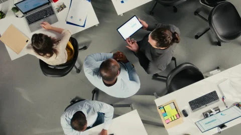 Top down view zoom in of employees consulting with executive management Stock Footage 320032284