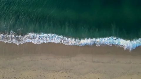 Top down waves crashing on shore Stock Footage 256942558