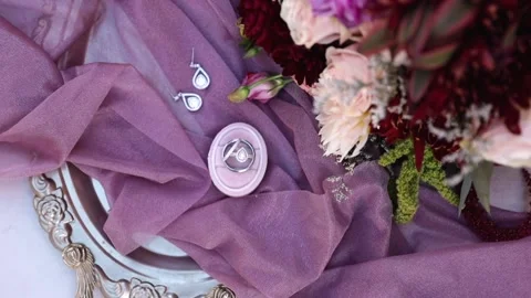 Top Down of Wedding Details: Rings, Earrings, Bouquet Stock-Footage 145228170