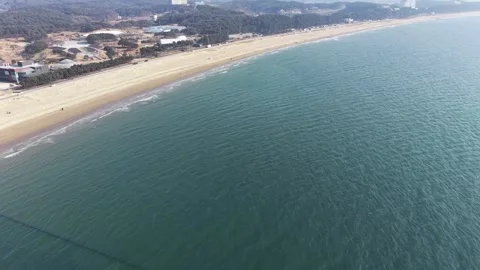 Top Down Wide Aerial View of Long Sandy Beach and Calm Korean Coast Stock Footage 344778372