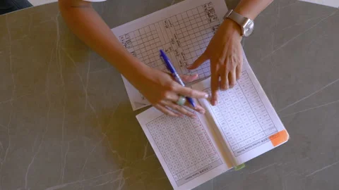 TOP DOWN: Young female using feng shui chart for energy flow analysis evaluation Stock Footage 195721594