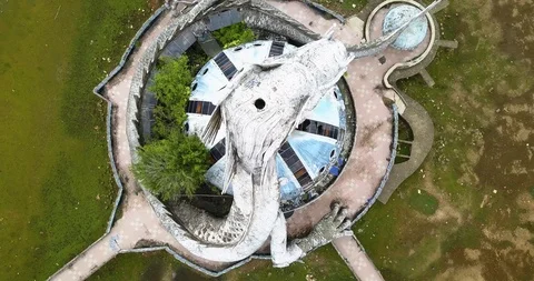 Top down zoom drone shot of giant abandoned dragon statue in Hue Vietnam Stock Footage 97429459