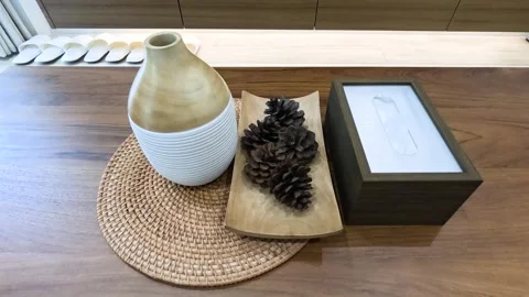 Top Down Zoom Out of Pine Cones and Ceramic Vase on Table Stock Footage 335799757
