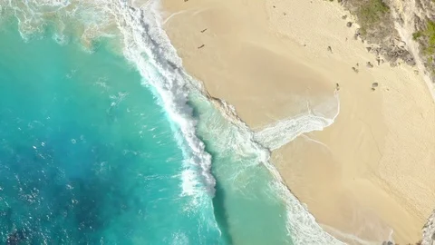 Top Down Zoom in Spinning Drone Shot of Big Waves Kelingking Beach at Nusa Pe Stock Footage 113766053