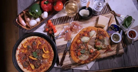Top down zoom in view of delicious Italian pizzas Stock Footage 73736925