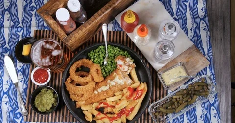 Top down zoom in view of an English fish and chips Stock Footage 77564019