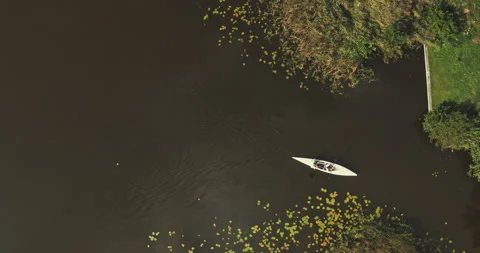 Top drone hot of two wite canoes paddling Stock Footage 221317545