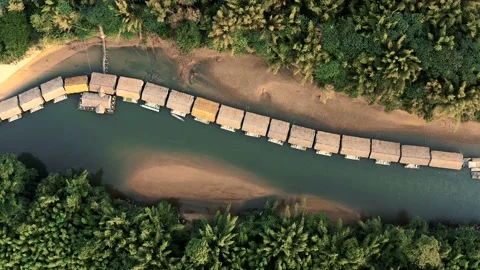 TOP DRONE SHOT UP TO DOWN OF FLOATING BUNGALOWS ON THE RIVER KWAI WITH JUNGLE Stock Footage 169163704