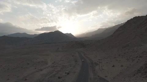 Top Drone View of a Ladakh Mountain Road with a Moving Car Surrounded by Vídeos de archivo 334403632