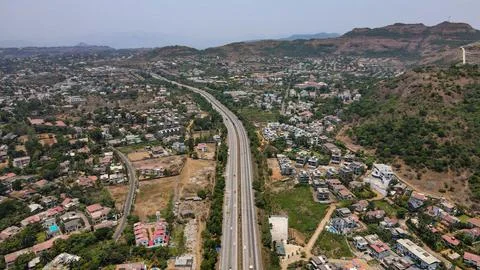 Top drone view to the Lonavala express highway surrounded by residential buildin 스톡 사진