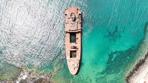 Top drone view of rusty shipwreck anchored Telamon near the shore in Arrecife Stock Photos
