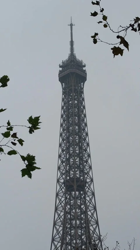 The top of the Eiffel Tower by a cloudy black and white winter day in Paris Stock Footage 257484871