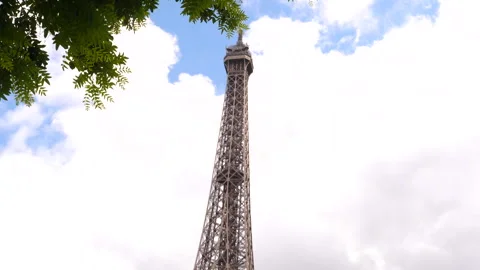 Top of the Eiffel Tower with spring branches, cloudy background Stock Footage 260696488