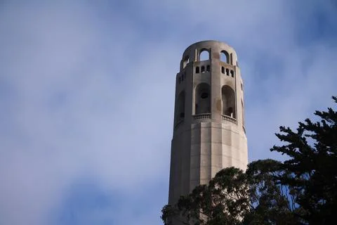 The top of the emblematic Coit tower with clouds behind in San Francisco Stock Photos