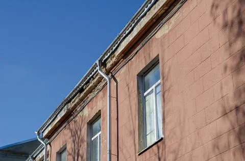 The top of the emergency building. Collapsing plaster on the facade of the bu Stock Photos