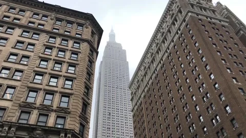 TOP OF THE EMPIRE STATE BUILDING APPEARS THROUGH THICK CLOUDS IN NYC Stock Footage
