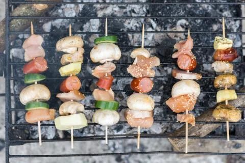 Top flat lay view of meat and vegetables kebabs on the grill Stock Photos