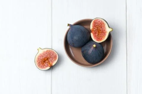 Top flat view: fresh figs on white wooden table Stock Photos
