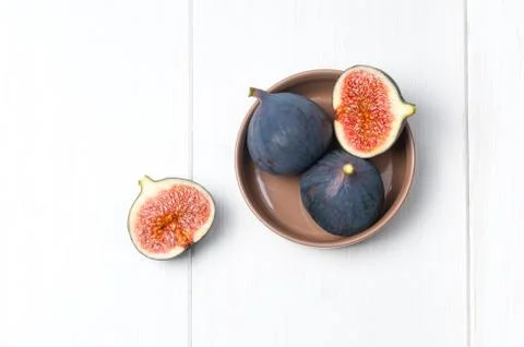 Top flat view: fresh figs on white wooden table Stock Photos