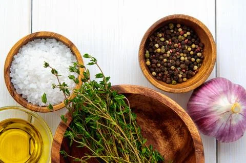 Top flat view of ingredients: salt, pepper, chili,  thyme, garlic, olive oil  Stock Photos