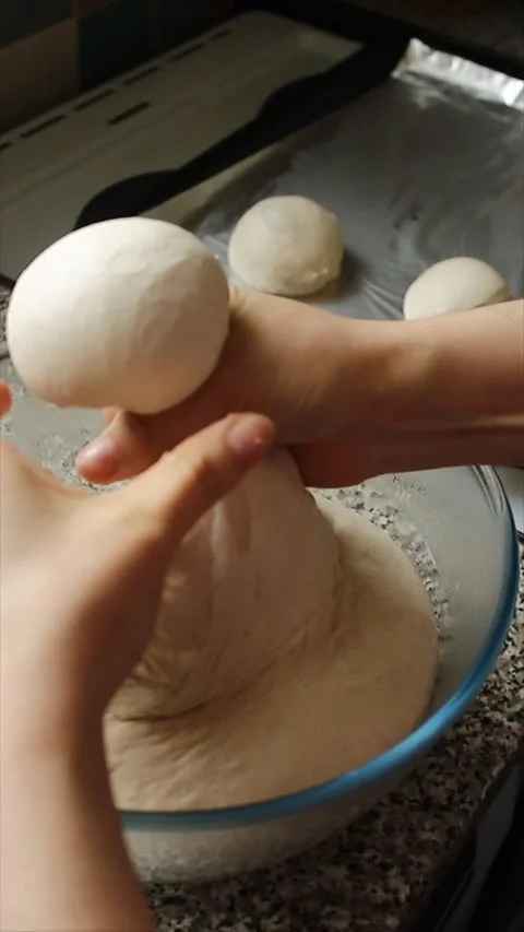 Top-front shot of the preparation of dough balls to be baked Stock Footage 303842408